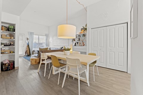 a dining room and living room with a table and chairs